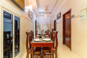 a dining room with a long table and chairs at 855 Villa Siem Reap in Siem Reap