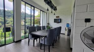 a dining room with a black table and chairs at Aura Residence-Kandy in Katugastota