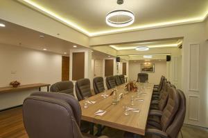 a conference room with a long table and chairs at Noah Sky Suites in Cochin +23 photos