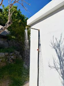 a water hose hooked up to a white wall at Ftero Traditional Retreat in Manganítis