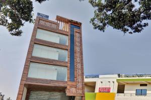 a tall brick building with a blue trim at Hotel O Rudra Palace Near Phoenix United Lucknow in Alambagh +16 photos