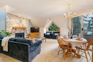 a living room with a couch and a table and a fireplace at 31GlenEagle Whistler in Whistler