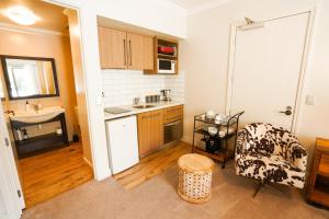 a small kitchen with a chair and a sink at Cardrona Ridge by Aotearoa Escapees in Cardrona