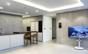 a kitchen with a tv on a wall at Stay in WAVE in Ch'ŏngsap'o