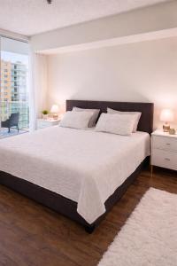 a bedroom with a large bed and a large window at 2b apartment by the Ocean in Sunny Isles Beach