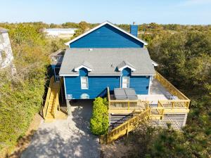 an aerial view of a blue house with a deck at 1602 - Here To Stay in Corolla