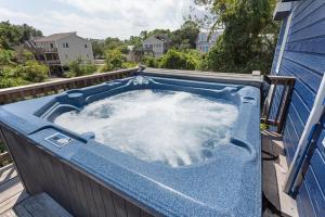 a hot tub on the roof of a house at 1602 - Here To Stay in Corolla
