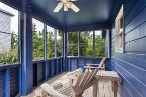 a porch with two chairs and a ceiling fan at 1602 - Here To Stay in Corolla
