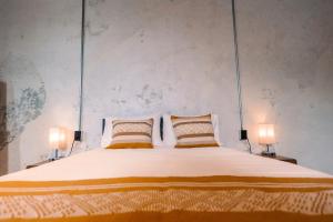 a bedroom with a large bed with two lamps at Nomaddicts in Mexico City