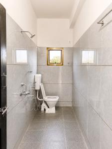 a bathroom with a toilet and a window at hotel raj palace in Londa