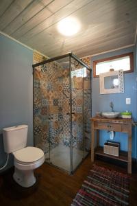 a bathroom with a shower and a toilet and a sink at Casa Linda na Barra de Ibiraquera - SC in Imbituba