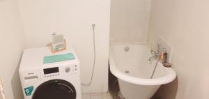 a bathroom with a washing machine and a toilet at Le bois saint Hilaire in Lémeré