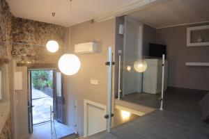 a room with a glass door and a mirror at A Casa di Ludo - Apartments & Short Lets in Catania +49 photos