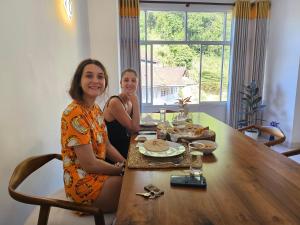 two women sitting at a table in a dining room at Kandy home in Kandy +48 photos