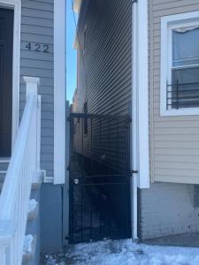 a black gate on the side of a house at Cozy Home 422 South 16th street in Newark