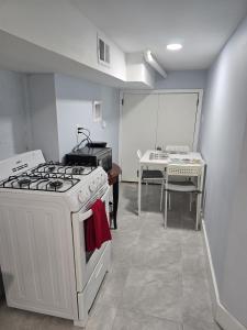 a kitchen with a white stove and a table at Cozy Home 422 South 16th street in Newark