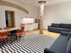 a living room with a table and chairs and a couch at Zema11 Old Town Space in Vilnius