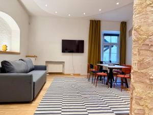 a living room with a couch and a table at Zema11 Old Town Space in Vilnius