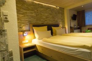 Postel nebo postele na pokoji v ubytování Wanderhotel Grüner Baum