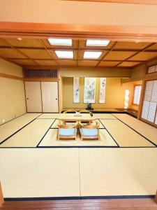 a large room with a table and two chairs at 红尘会馆 in Kishiwada