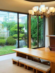 a dining room with a table and a large window at 红尘会馆 in Kishiwada