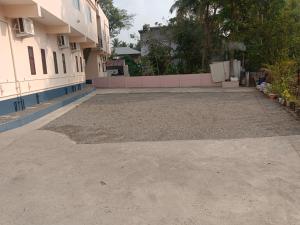 an empty parking lot in front of a building at Hotel Sindoor Inn in Parli +6 photos