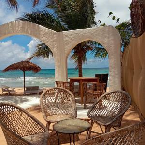 a group of chairs and tables on the beach at Memo's Beach in Nilaveli