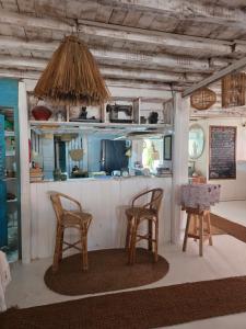 a kitchen with two chairs and a table at Memo's Beach in Nilaveli