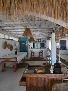 a living room with a table and a kitchen at Memo's Beach in Nilaveli