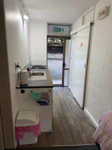 a kitchen with a sink and a counter top at AAA Mana Motel in Porirua +35 photos