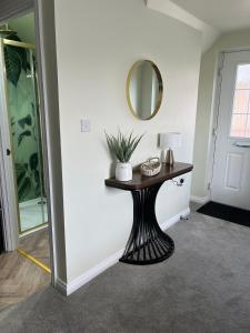 a room with a table with a mirror on the wall at Loft Studio in Davenham