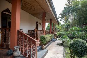 a porch of a house with a wooden railing at SouanSonBeachResort in Klaeng