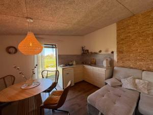a living room with a couch and a table at Mango namelis in Žuvininkai