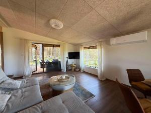 a living room with a couch and a table at Mango namelis in Žuvininkai
