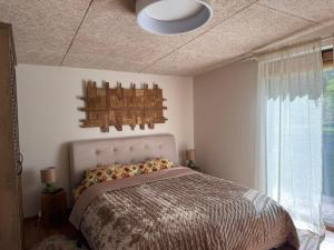 a bedroom with a bed and a ceiling at Mango namelis in Žuvininkai