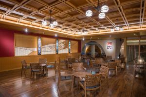 a restaurant with tables and chairs in a room at Notoya in Komatsu