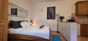 a bedroom with a bed with a book on it at Studio Apartman DORA in Senj