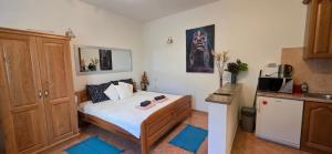 a small bedroom with a bed and a kitchen at Studio Apartman DORA in Senj