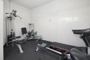 a gym with treadmills and machines in a room at Summit Apartments Brisbane City in Brisbane