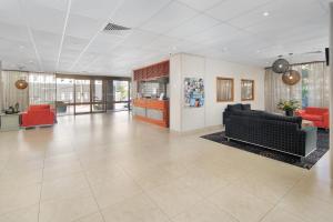 a large lobby with couches and chairs in a building at Summit Apartments Brisbane City in Brisbane
