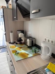 a kitchen with a counter with a toaster and a microwave at Ferienwohnung Lange in Brilon