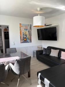 a living room with a black couch and a table at Ferienwohnung Lange in Brilon