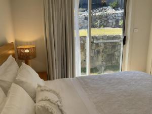 a bedroom with a white bed and a window at Chay's Guest House in Coffs Harbour