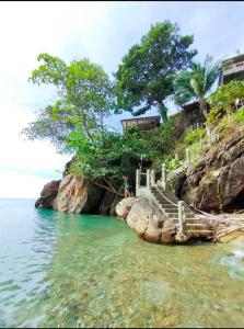 a stairway to the ocean on a rocky shore at Cliff View Bungalows in Ko Chang