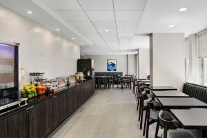 a dining room with tables and chairs and a counter at Fairfield Inn and Suites Chicago Downtown/ Magnificent Mile in Chicago