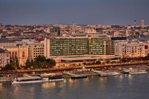 a large building next to a body of water at Budapest Marriott Hotel in Budapest