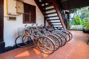 a row of bikes parked next to a wall at Ban Lakkham River View in Luang Prabang