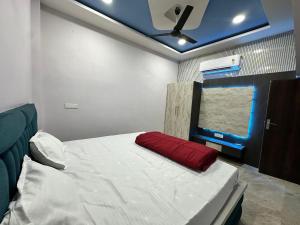 a room with a bed with a red pillow on it at Mitanvi the heaven in Ujjain +22 photos