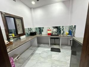 a kitchen with a counter and a table in a room at Mitanvi the heaven in Ujjain