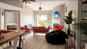 a living room with a couch and a table at Corporate Retreat - Stylish 2BR Condo with Pool, Balcony & Fast Wi-Fi, Minutes from Downtown Wilmington in Wilmington